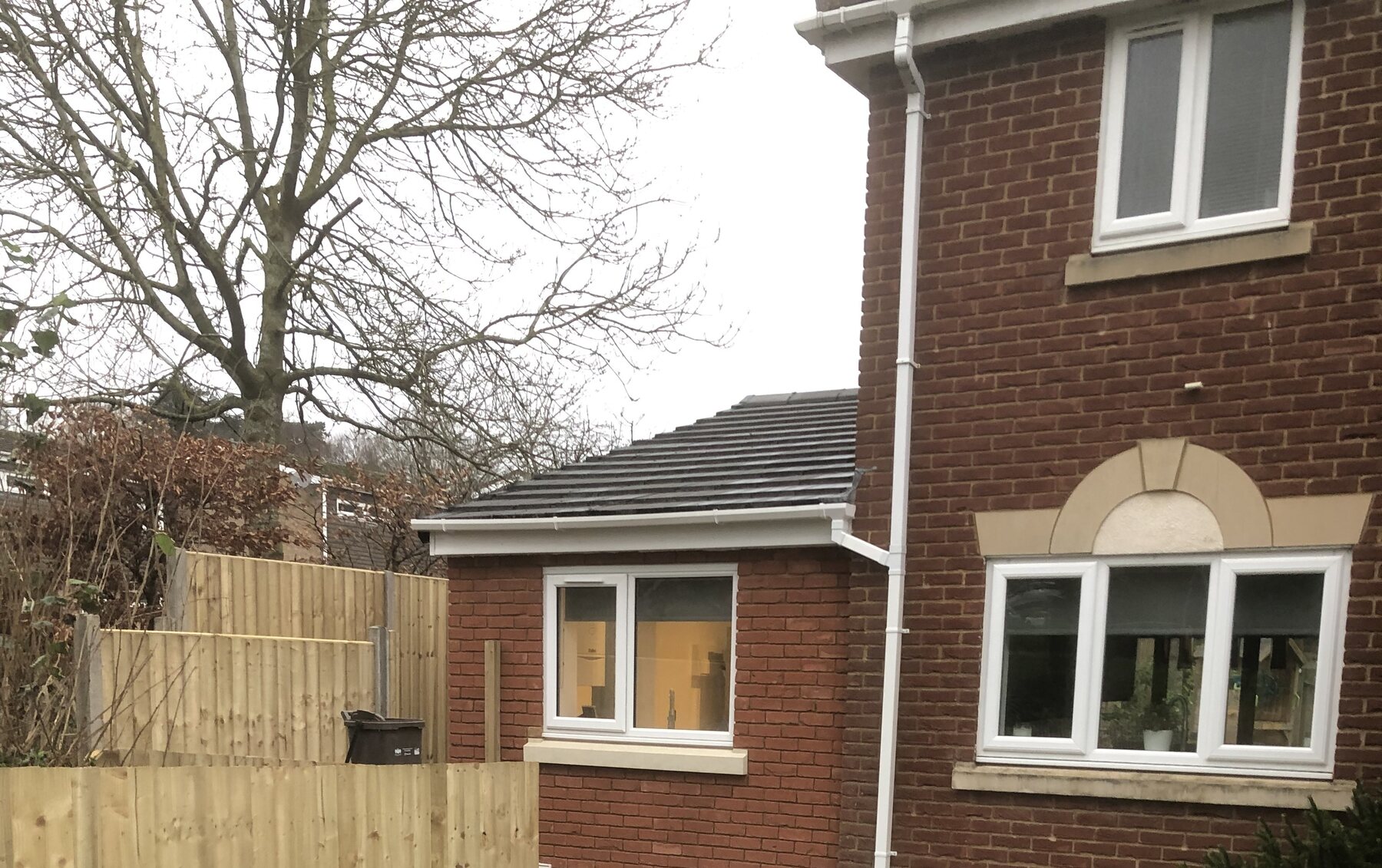 Completed single-storey brick extension in Daventry viewed from the garden