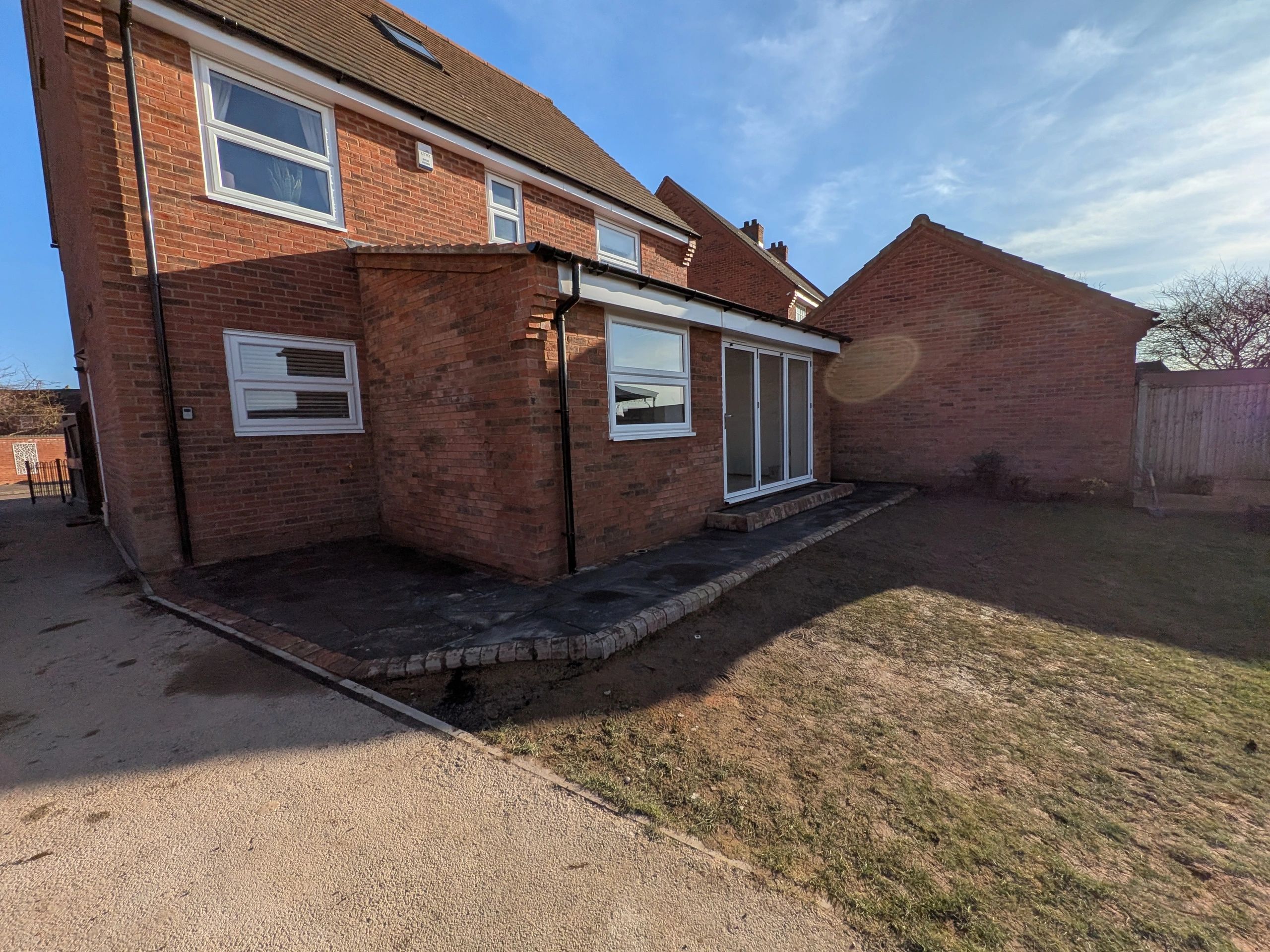Completed brick single-storey extension, angled exterior view