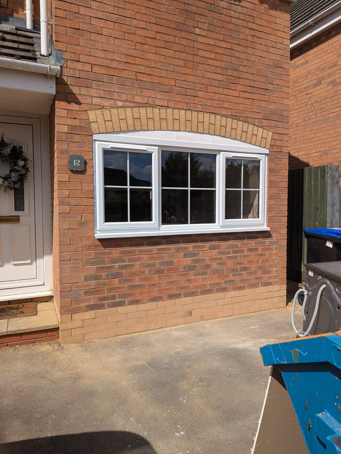 Completed garage conversion exterior with new window and matching brickwork
